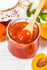 Apricot Jam with Fresh Summer Apricot on White Wooden Background. Selective focus.