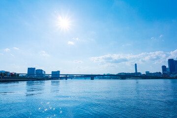 Naklejka premium Tower apartments lined up along the river and a refreshing blue sky_14