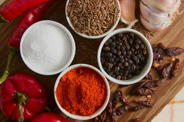 Flat lay of a table with different culinary spices and condiments