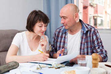 Fototapeta premium Husband and wife consider family budget. High quality photo