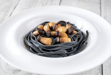 Black pasta with baby mushrooms