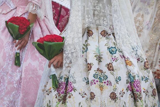 Detail of traditional floral dresses with flower offerings at the celebration 'Fallas', Valencia, Spain