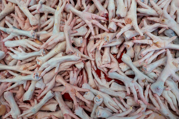 Close up fresh chicken feet in the market