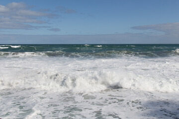 Fototapeta na wymiar Marine Landscape with big waves, horizon line and blue sky.