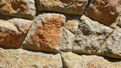 Texture of a stone wall made of natural stone with mosaic masonry for background.