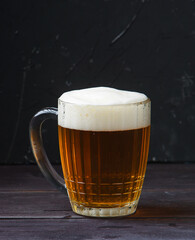 glass of beer on dark background dark wooden table