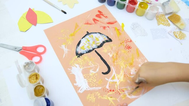 Autumnal card . Child paint umbrella and autumn park use sponge and paintbrush, crafts for kids.
