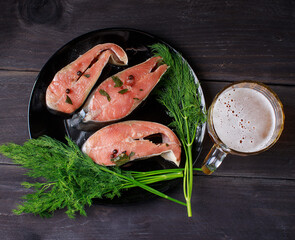 Salmon and beer on wooden background