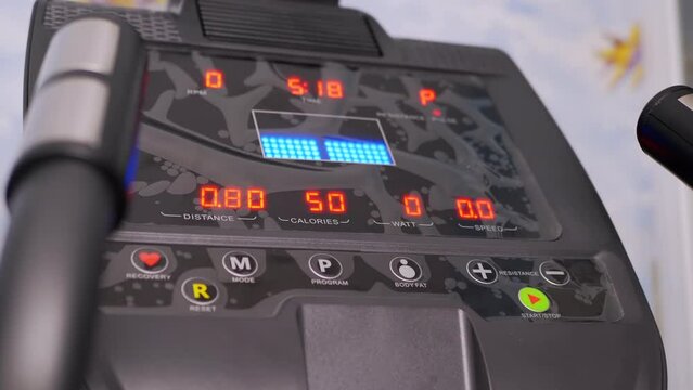 Electronic Indicators of Data on the Monitor a New Modern Elliptical Trainer. Choosing a program for training on a cross-trainer. Indicators of distance, speed, calorie consumption, time, heart rate.
