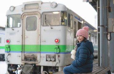 Asian girl waiting for train on winter day