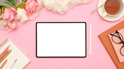 Stylish pink female office workspace top view with digital tablet mockup