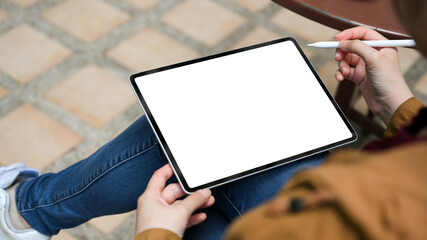 A female college student using a portable tablet with stylus pen