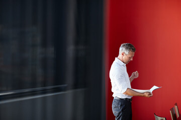 Making sure he brings his A-game to the meeting. Shot of a handsome businessman going through his...