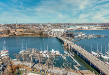 Aerial summer view of Annapolis harbor with the  draw bridge over spa creek, sailboats docked, state capital, united states naval academy and historic buildings in the background