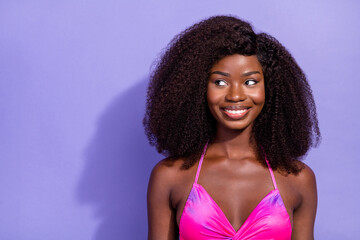 Photo of dreamy sweet african lady dressed pink sexy clothes smiling looking empty space isolated violet color background