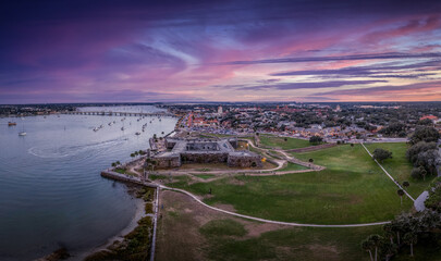 Stunning aerial sunset shot of St Augustine Florida, Castillo de San Marcos with four cannon bastions purple, blue, red sky - obrazy, fototapety, plakaty