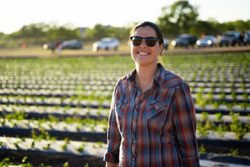 woman with sunglasses in front of farm