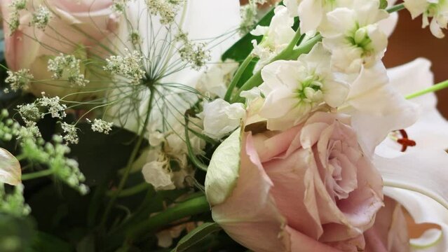 A valentines bouquet with white lilies and pink roses.