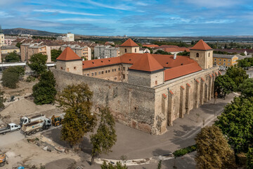 Obraz premium Aerial view of the back of Thury castle in Varpalota Hungary with four square towers restored palace building and buttresses supporting the castle wall