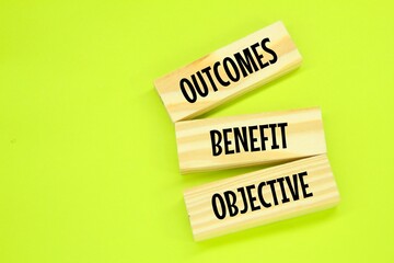 wooden board with the words Objective Benefit Outcomes