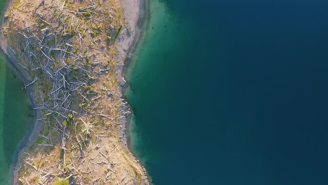 Overhead aerial shot of the turquoise water lake and forest in Corazon de la Isla, Tierra del Fuego, Patagonia Argentina.