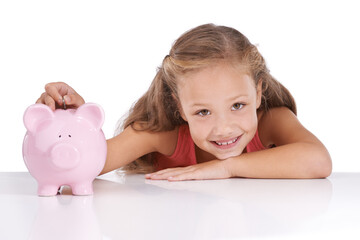 Saving for her future. Shot of a cute young girl with a piggybank.