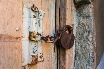 the old wooden door is locked with a close-up