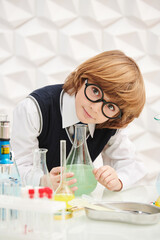 clever schoolboy making experiments