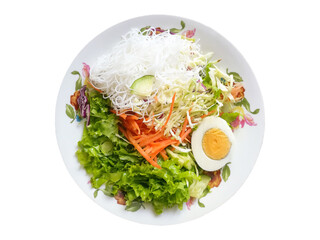 Vegetable salad served on a plate with glass noodles and a half-boiled egg which contains nutrients like carbohydrates, proteins, and vitamins. Clean food on white background with a clipping path