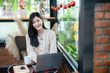 Portrait freelance business beautiful positive smile young asian woman online working with laptop computer and smartphone on notebook at home in the living room indoors or the cafe,Business Lifestyle