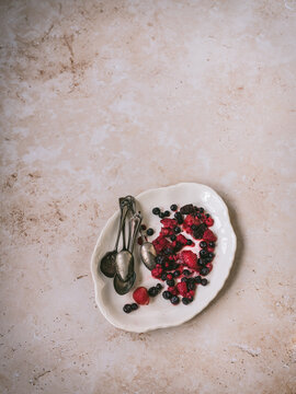 Berries on a white serving dish - moody
