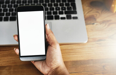 Checking her messages. High angle shot of an unrecognizable businesswoman using a mobile phone.