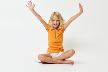cute girl with blond hair sitting on the floor