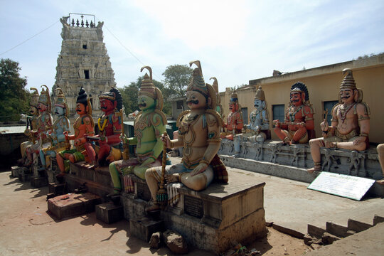 Indian temple, many dieties - sculptures sitting in front. 
