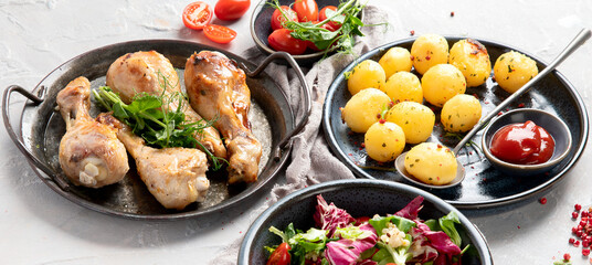 Baked chicken legs with salad and potatoes