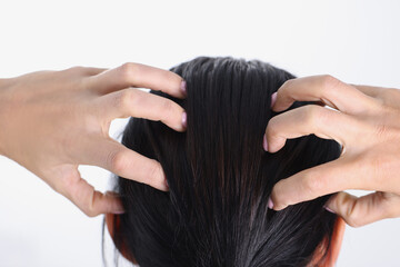 Naklejka premium Close-up of female hands massaging her head