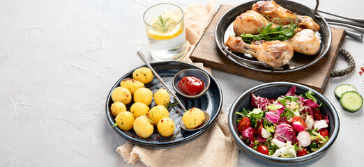 Baked chicken legs with salad and potatoes