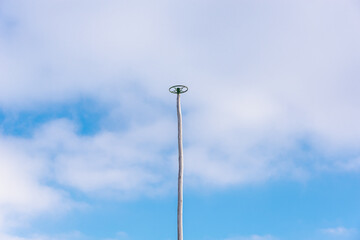 High pole for climbing athletes on the background of the sky.