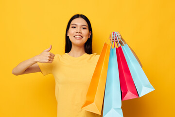 Charming young Asian woman fashion shopping posing isolated background unaltered