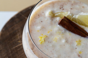 Close up of Spanish dessert aroz con leche,rice pudding in with stick of cinnamon and lemon