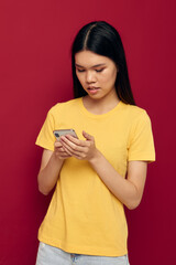 woman uses the phone on a red background