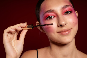 Portrait of beautiful young woman pink face makeup posing attractive look skin care cropped view unaltered