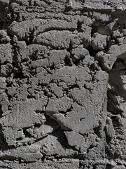 Closeup photo of old gray cement background under brick wall