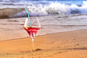 Wine glass with a cocktail by the sea.