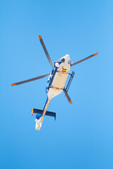 Canvasing the area. Low angle shot of a police helicopter in the sky. © Jose M/peopleimages.com