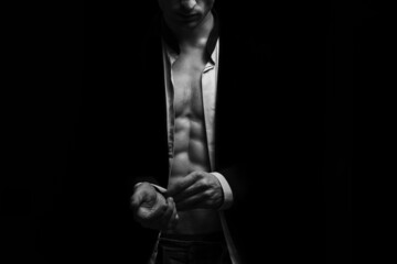 Man with a naked torso on a black background