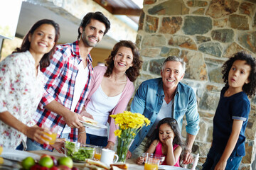 Ready to enjoy a family meal. A happy family enjoying a meal time together.