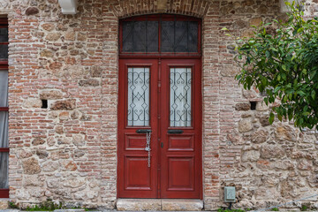 Fototapeta na wymiar Close-up of a brown wooden door in an old stone mansion house