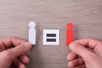 Concept equality between racial diversity with hands holding cutouts