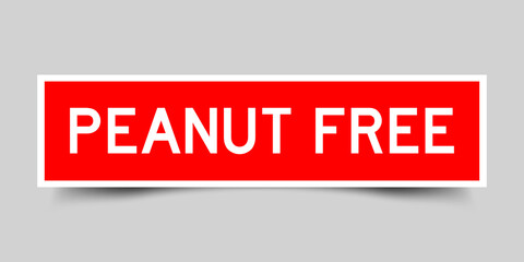 Inserted red color label sticker with word peanut free on gray background